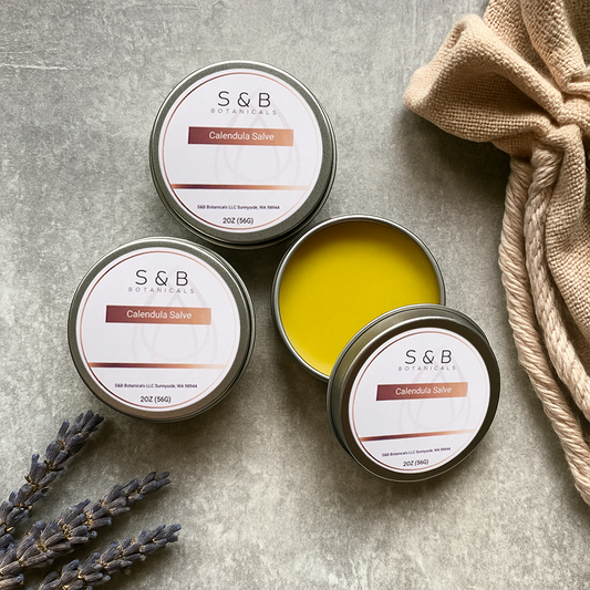 Close-up of calendula salve showing smooth herbal balm texture inside metal tin