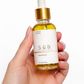 Calendula face and body oil held in hand for size reference