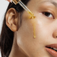 Calendula face and body oil displayed with calendula flowers and botanical ingredients