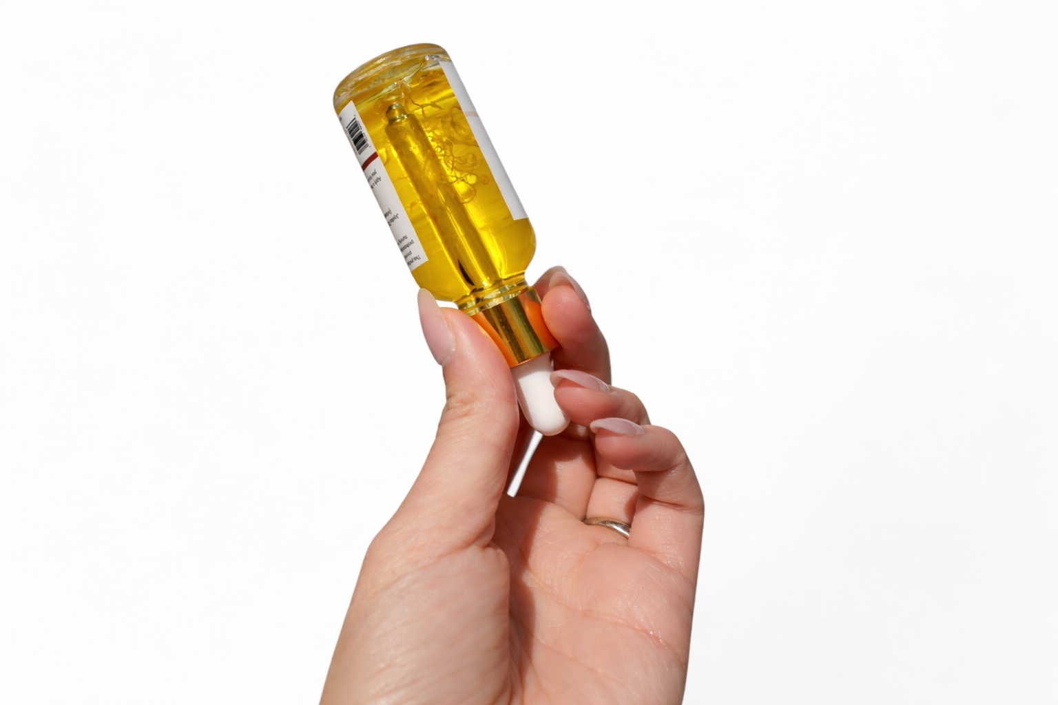 Calendula herbal glow oil applied to skin showing radiant hydrated finish