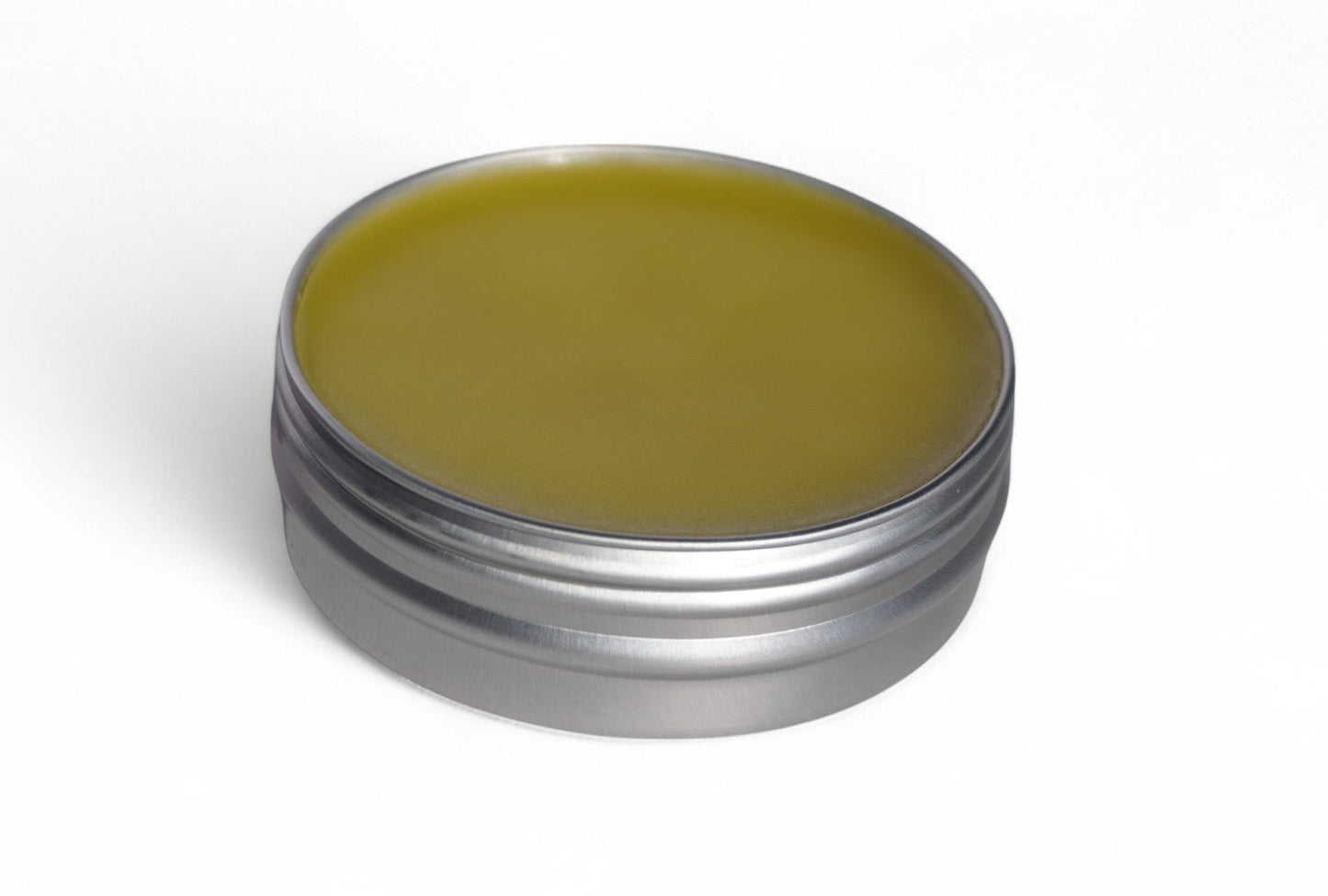 Applying calendula salve to skin for moisturizing dry areas like hands, elbows, and cuticles
