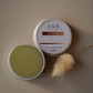 Comfrey salve 2 oz tin styled in flat lay with natural herbal skincare aesthetic and clean background