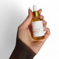 Close up of rosemary peppermint hair oil label herbal infused botanical scalp oil glass bottle